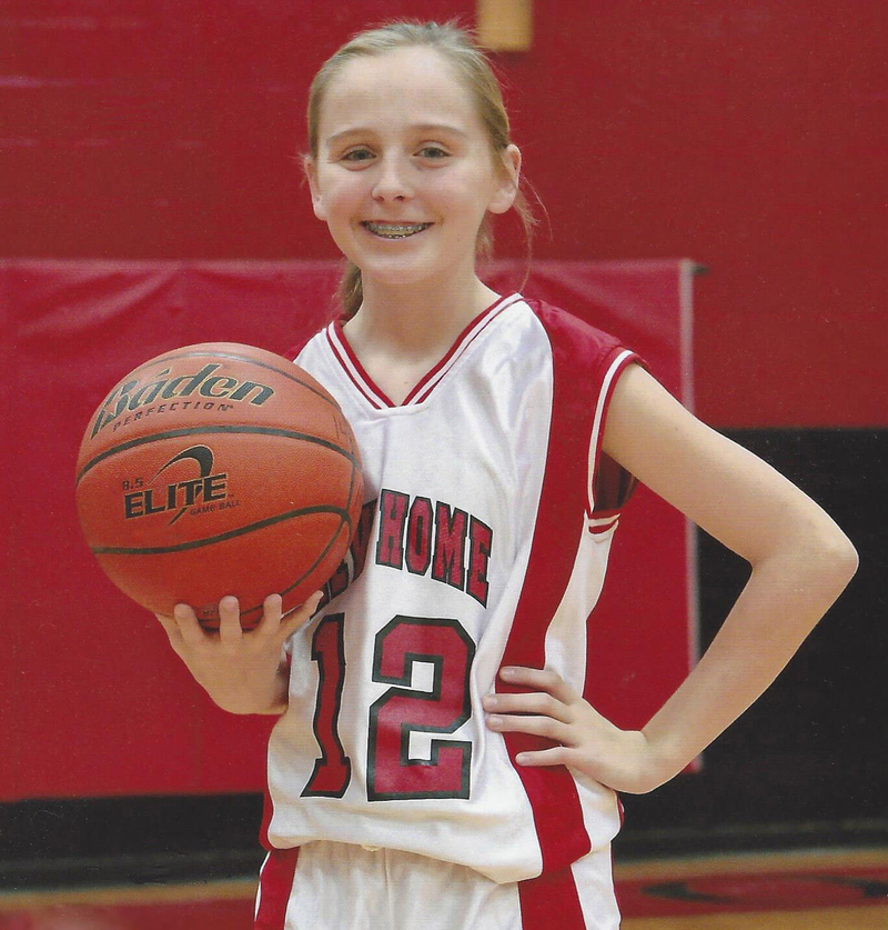M'Kenna playing her favorite sport, basketball.